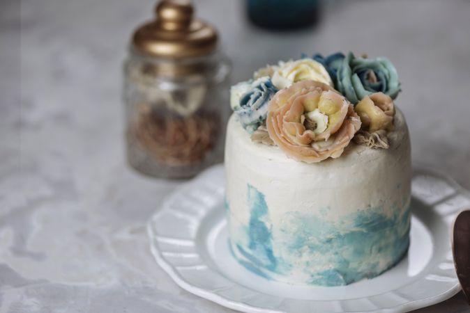 Buttercream flowers cake, blue and pastel peach colors