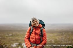 Smiling woman on a hiking trip on a hill on a winter day 4ZOL3b