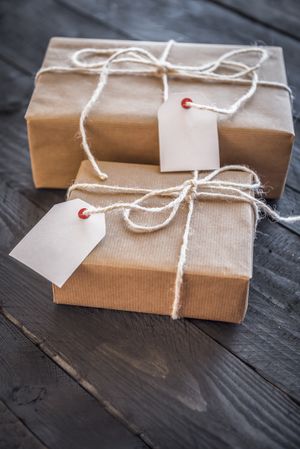 Two presents wrapped with brown paper and tags