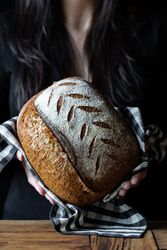 Crop person holding some bread