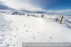 Snowy fence in ski resort of Sierra Nevada in winter 4ByBd5