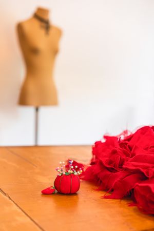 Empty mannequin, garment and a pincushion. Stylish and fashion concept