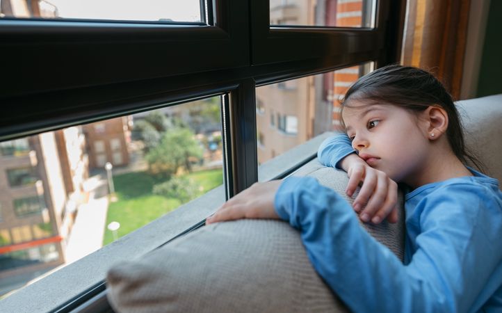 Sad girl looking out the window