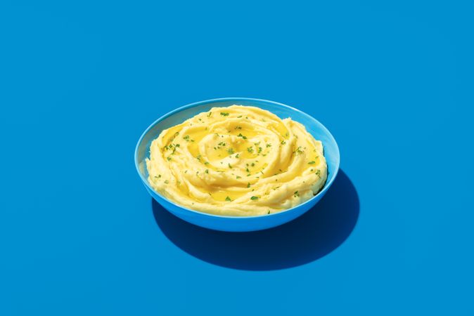 Mashed potatoes bowl minimalist on a blue background