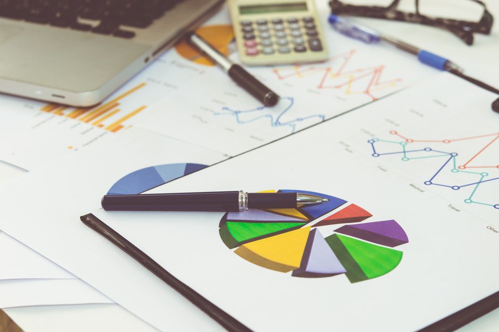Business Analysis with Charts, Graphs, and Financial Documents on Office Desk