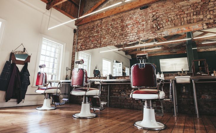 Horizontal shot of empty chairs in retro styled barbershop