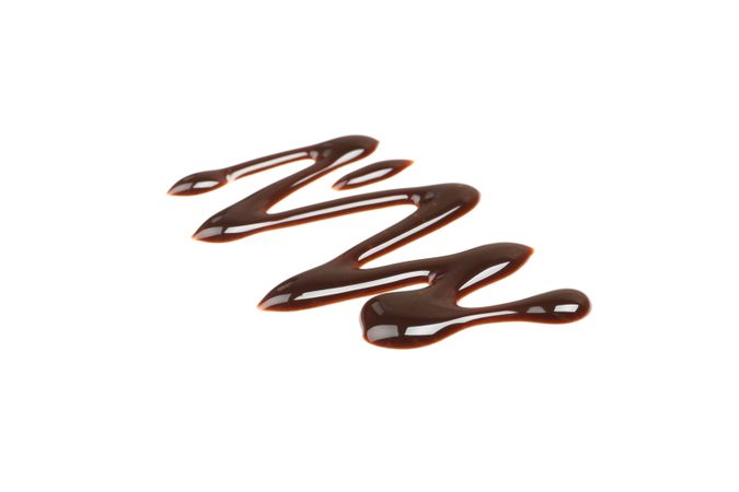 Tasty melted chocolate isolated on blank background