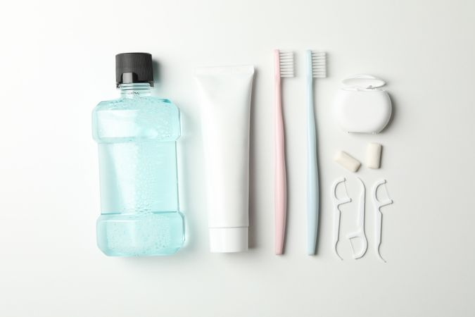 Flat lay with tools for dental care on light background