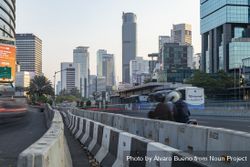 Jakarta, Indonesia - Oct 20, 2019: Skyline of skyscrapers in Jakarta, bus and motorcycle traffic 4jaJz5