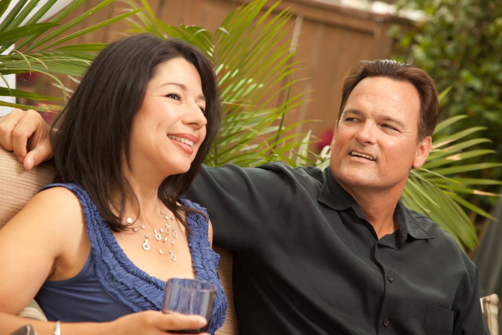 Hispanic and White Couple Drinking Wine