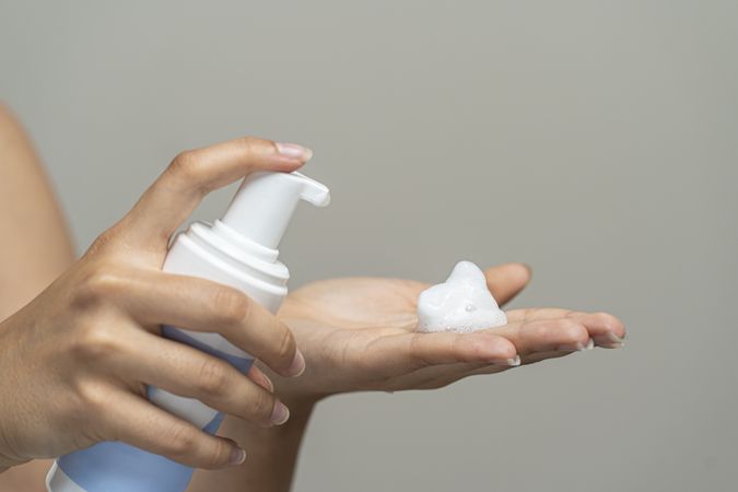 Foaming cleanser skincare product from soap dispenser pump bottle; hand wash in beauty routine.