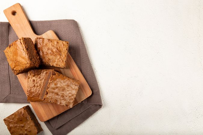 Top view of wooden board of brownies with space for text