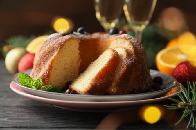 Cake with powdered sugar, berries and mint on wooden background, close up