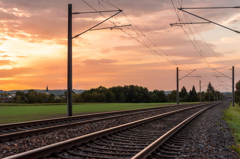 Sunrise landscape with railroad tracks in a german village