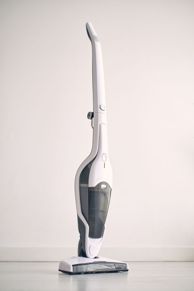 Contemporary vacuum cleaner placed on floor in apartment
