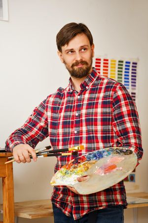 Male artist holding paint palette