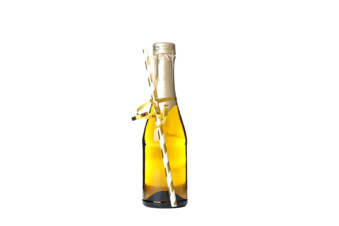 Mini champagne bottle with straw isolated on light background