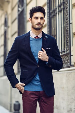 Attractive man in the street wearing elegant suit looking ahead
