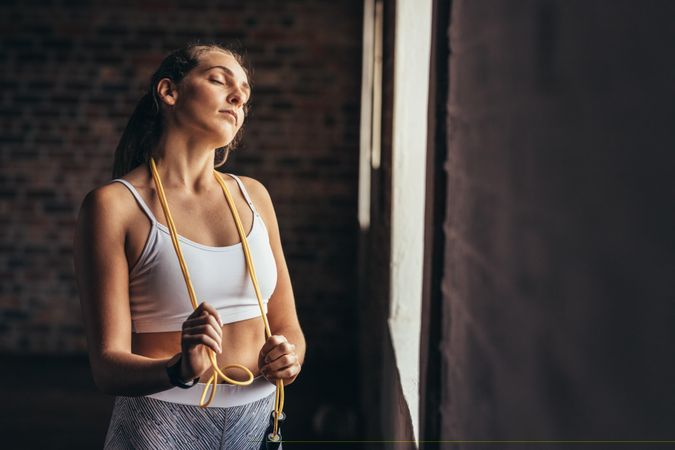 Fitness woman taking break after workout at gym