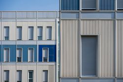Facade of modern multicolored building with narrow windows