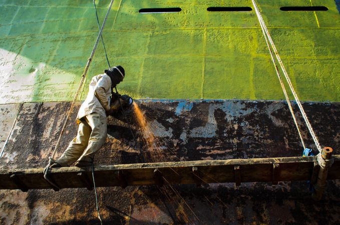 Man welding a part of a ship in Bangladesh