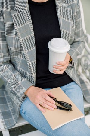 Crop woman with cup of coffee