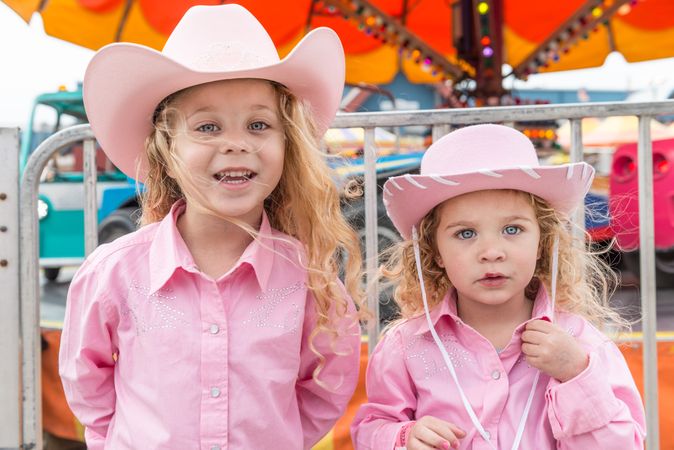 Two girls in pink cowgirl attire enjoy a day at Rodeo Austin, Austin, Texas