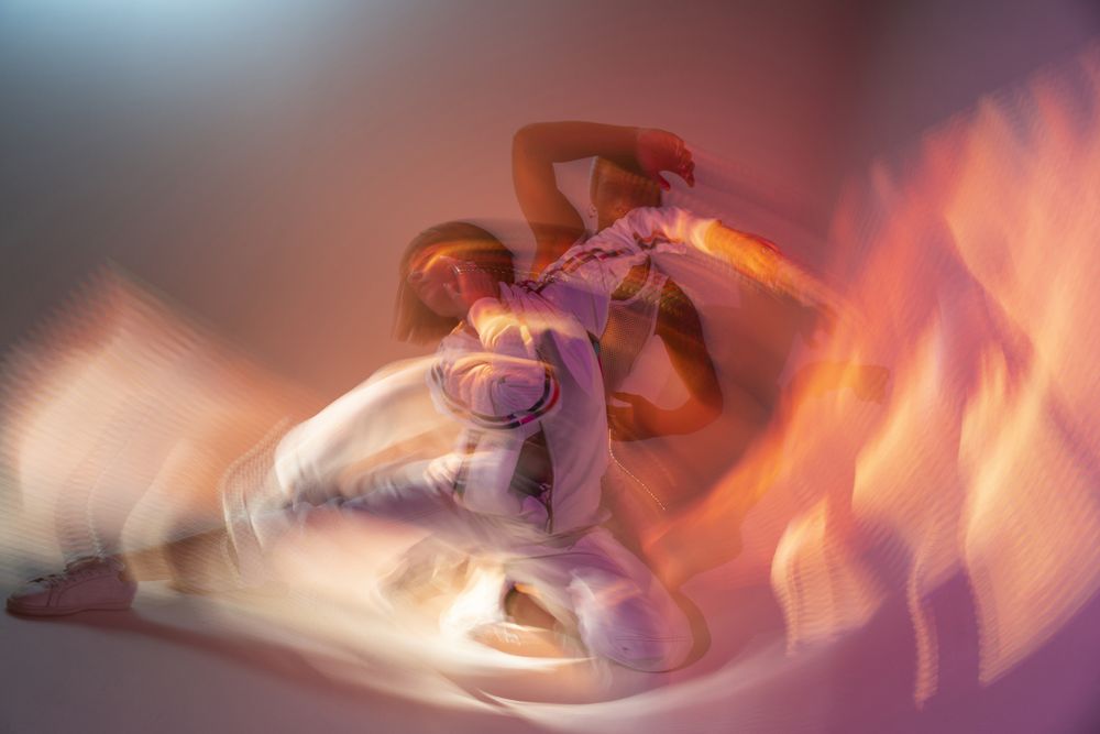 Anonymous dancers under violet illumination