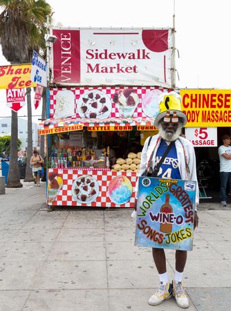 Black man with funny sign on Venice Beach Boardwalk