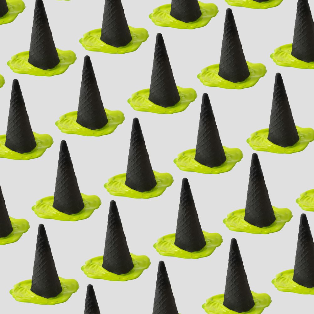 Rows of green ice cream melting under dark cone in halloween concept