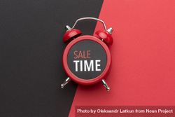 Alarm clock on red background with “Sale Time” on it 0gxl85
