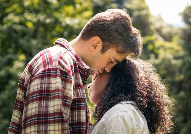 First love: young lovers kissing in the park