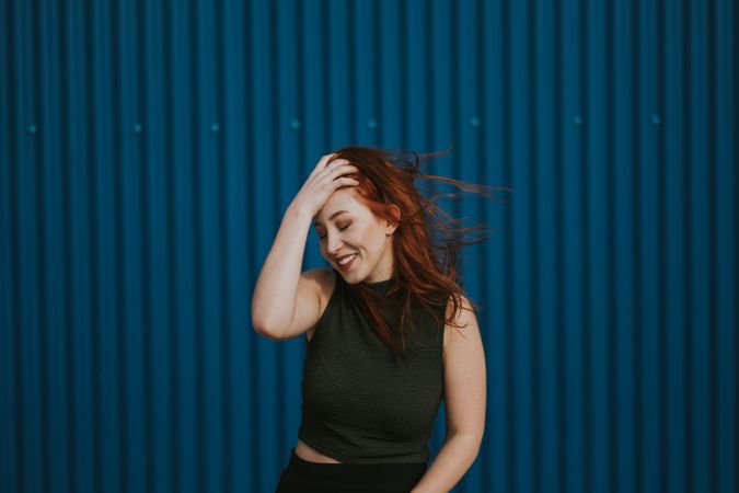 Smiling woman squinting in sun and enjoying weather