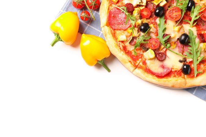 Tasty pizza, ingredients and towel isolated on blank background