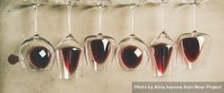 Glasses of red wine glasses laying on grey background, wide composition 5o3vk5