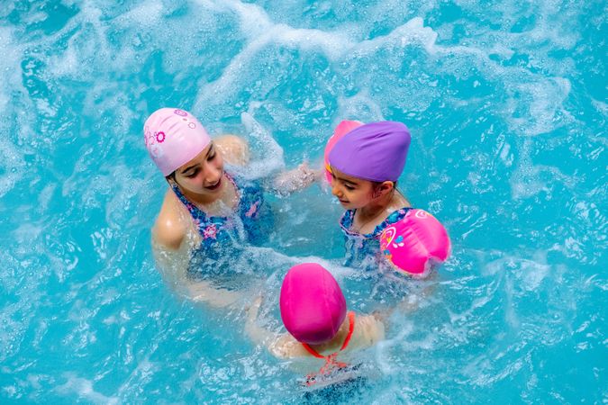 girls with water wings in swimming pool