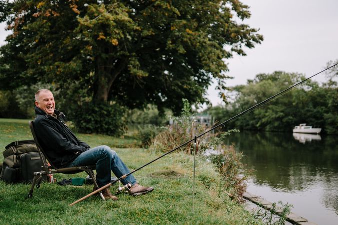 Happy man fishing in river