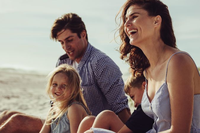 Beautiful family sitting on the beach