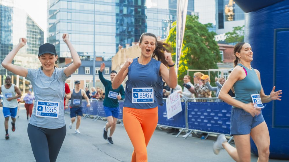 Women Supporting Women: Portrait of Happy Female Runners Participating in a Marathon.