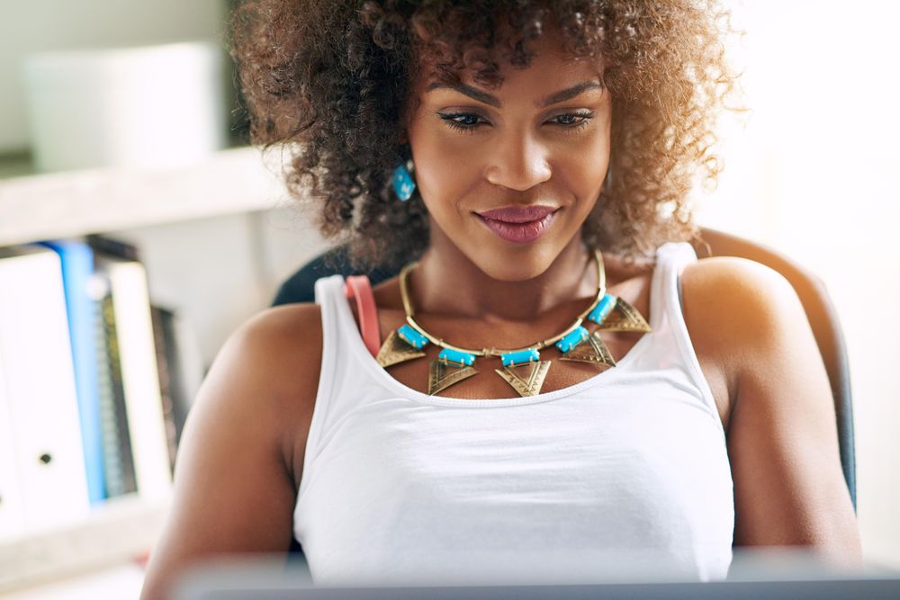Portrait of beautiful female working on laptop