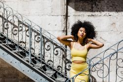 Stylish female leaning on railing outdoors