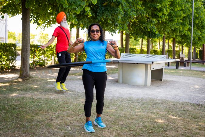 Mature Sikh couple doing workouts in park