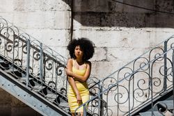 Stylish female leaning on railing outdoors