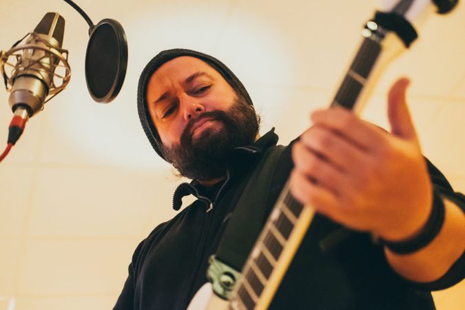 Musician playing guitar and singing