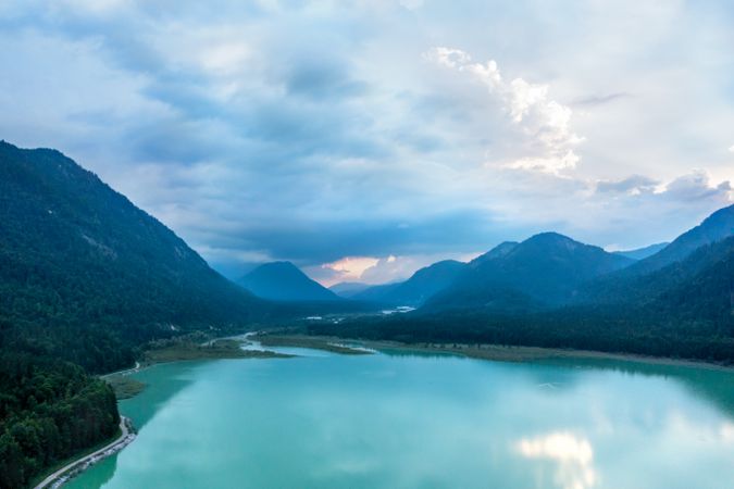 Drone aerial view at sunset with Lake Sylvenstein surrounded by Bavarian Alps, in Germany