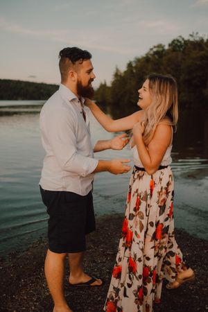 Loving couple standing ankle deep in water on beach