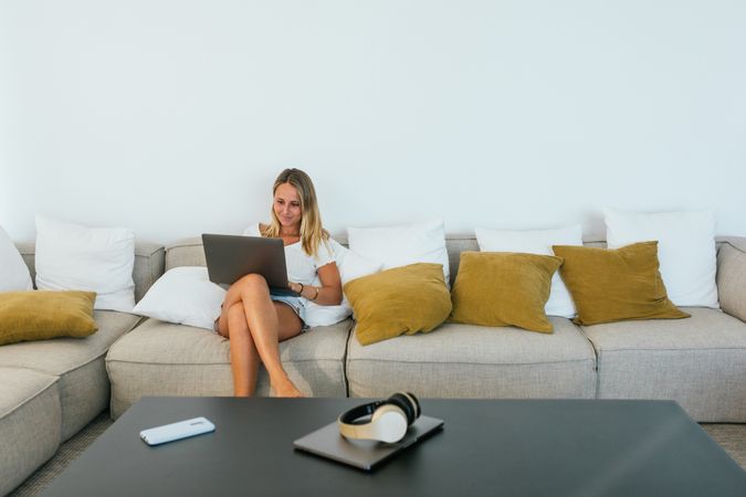 Woman browsing laptop on couch