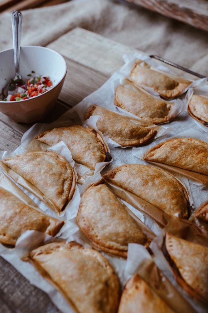 Baking tray with composed freshly baked pies patty