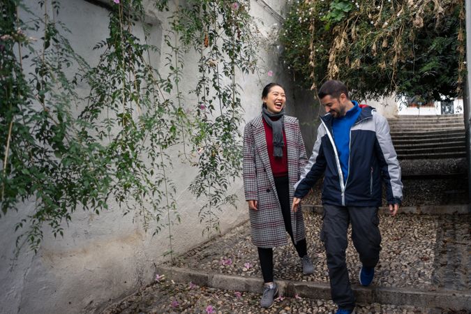 Pleased diverse couple exploring ancient town together