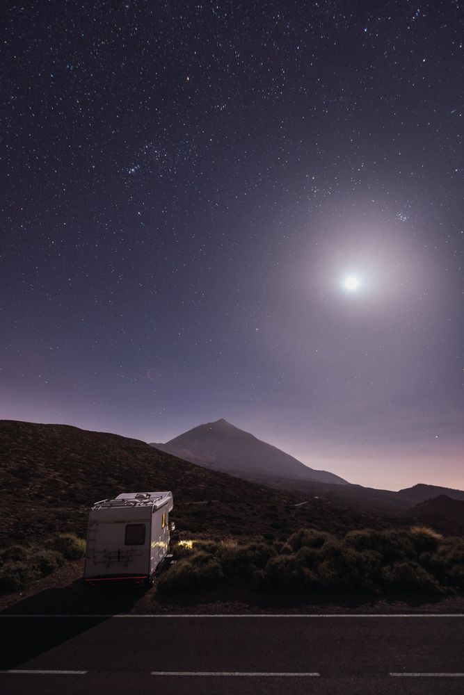 Traveling caravan in desert with bright moon